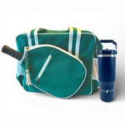 Green and white pickleball bag with paddle in pocket and navy tumbler cup